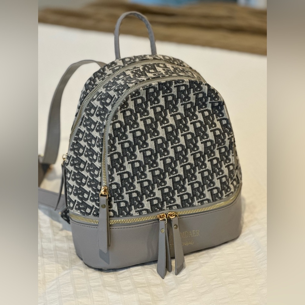 Grey backpack with gold accents